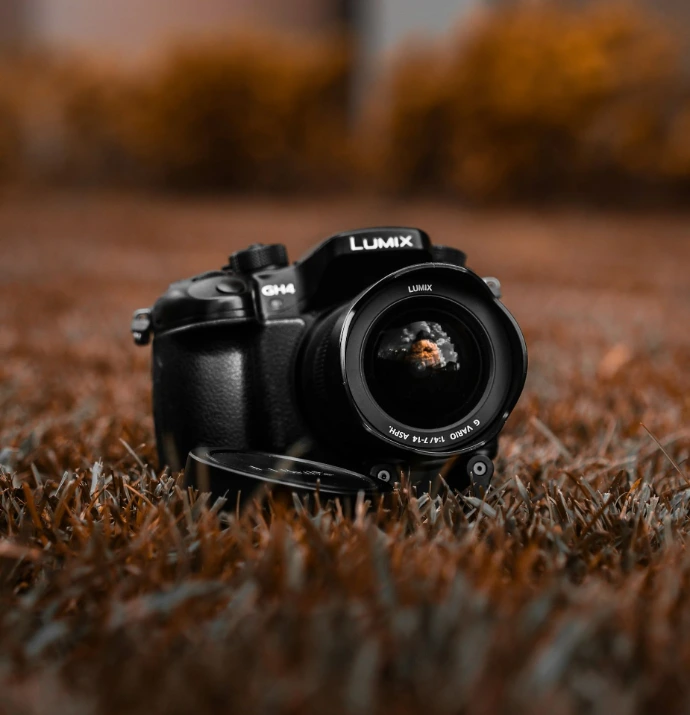 black nikon dslr camera on brown grass